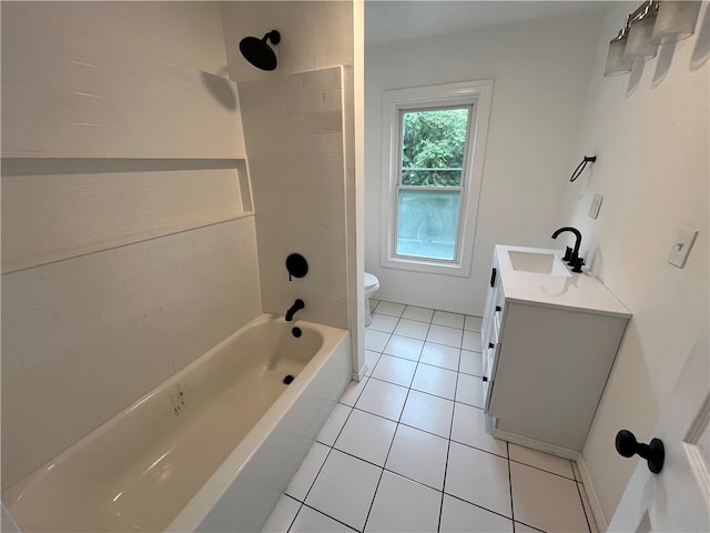 full bathroom featuring tile patterned floors, tiled shower / bath, vanity, and toilet