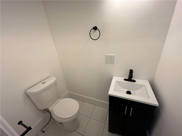 bathroom with vanity, toilet, and tile patterned floors