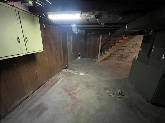 basement featuring wood walls