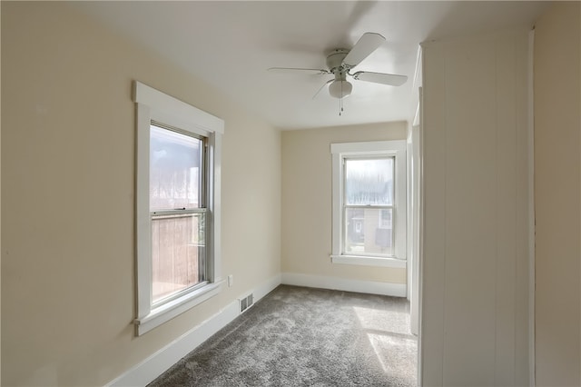 spare room with ceiling fan, carpet, and a healthy amount of sunlight