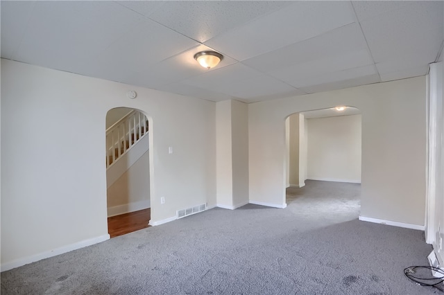 empty room with dark colored carpet