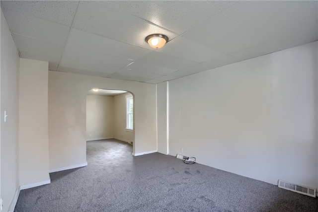 empty room with a paneled ceiling and carpet