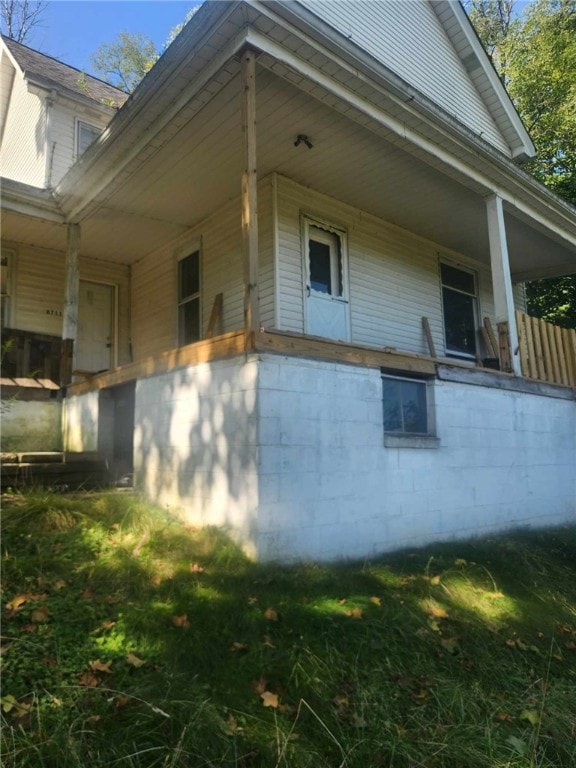 view of side of home with a porch