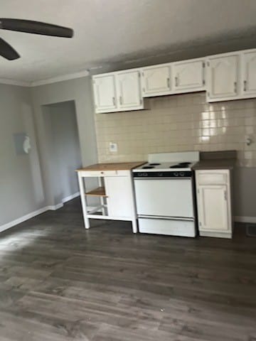 kitchen featuring dark hardwood / wood-style floors, white stove, white cabinetry, decorative backsplash, and ceiling fan