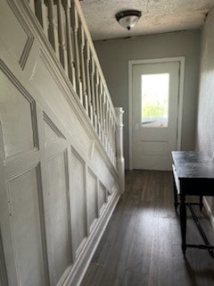 entryway with a textured ceiling and dark hardwood / wood-style floors