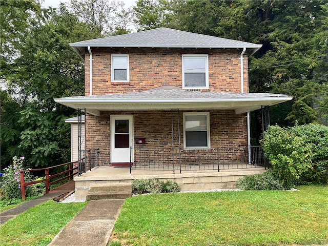 view of property featuring a porch and a front lawn