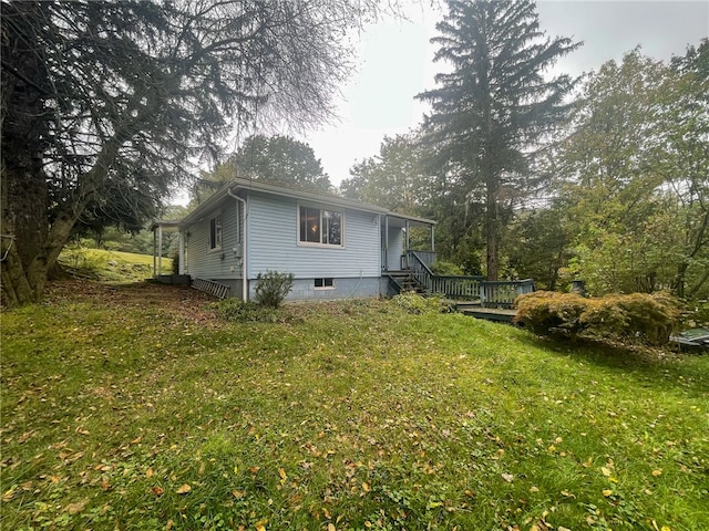 view of home's exterior with a deck and a lawn