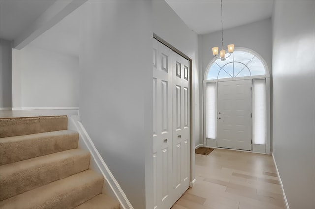 foyer entrance featuring a notable chandelier and light hardwood / wood-style flooring