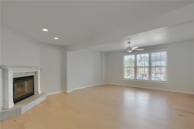 unfurnished living room featuring light hardwood / wood-style flooring and ceiling fan