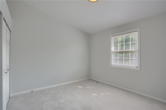 empty room featuring light carpet