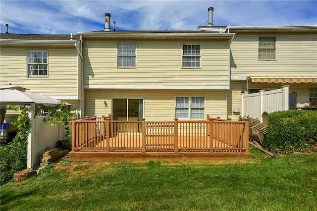 rear view of house featuring a lawn, a gazebo, and a deck