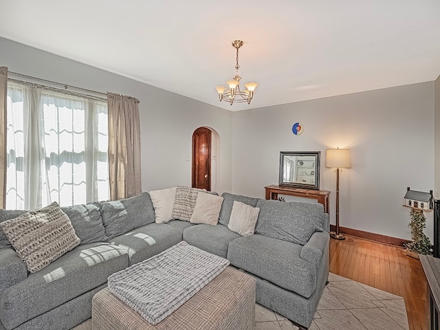 living room with an inviting chandelier and light wood-type flooring