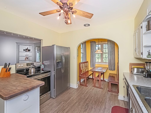 kitchen with sink, white cabinets, light hardwood / wood-style flooring, stainless steel appliances, and ceiling fan