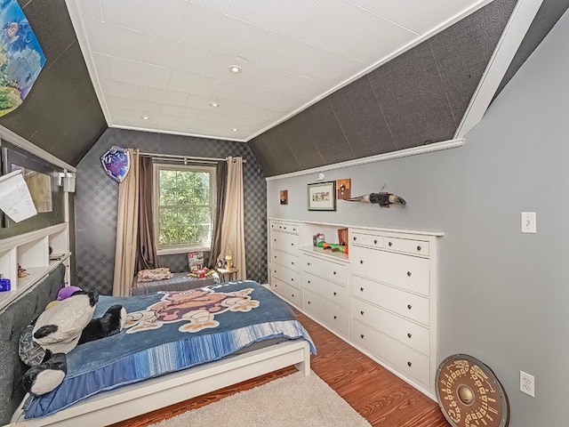 bedroom featuring lofted ceiling and hardwood / wood-style floors