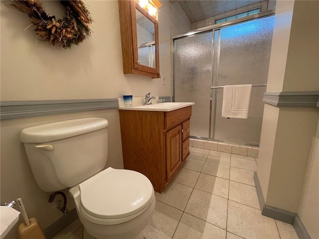 full bathroom featuring toilet, vanity, a shower stall, and tile patterned floors