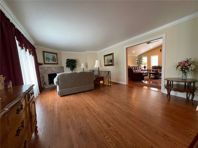 living room with wood-type flooring, lofted ceiling, and crown molding