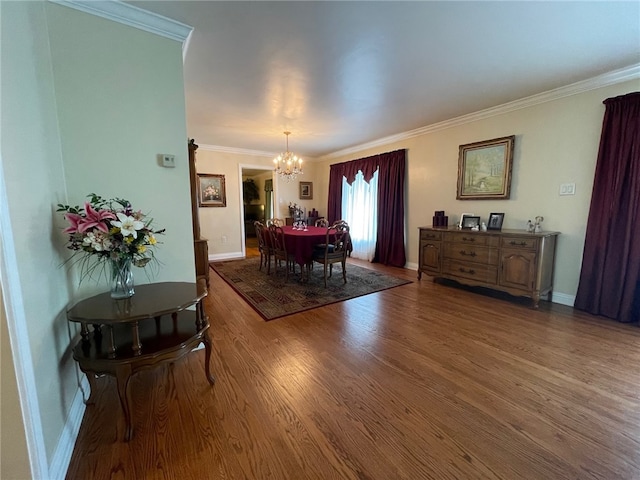 living room with ornamental molding, an inviting chandelier, and hardwood / wood-style floors