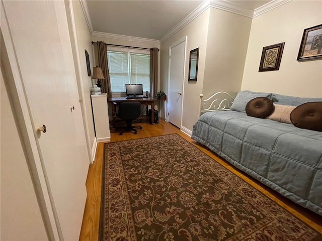 bedroom featuring light wood-type flooring and ornamental molding