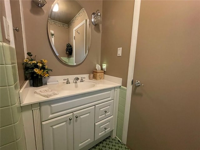 bathroom with vanity, tile patterned floors, and a wainscoted wall