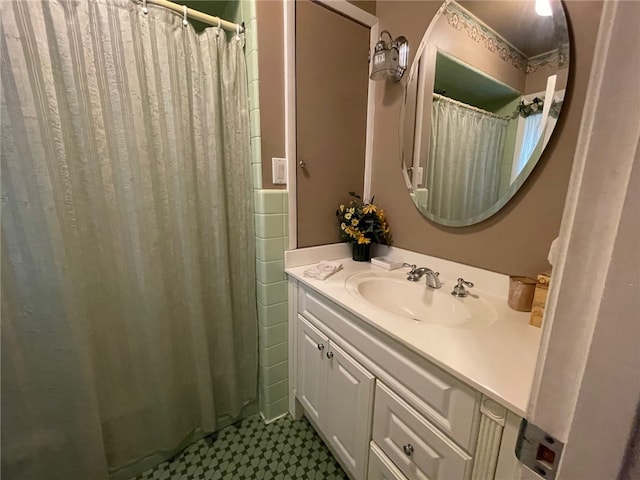 bathroom featuring vanity and a shower with shower curtain