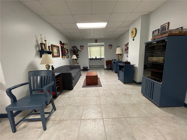 tiled living room with a drop ceiling