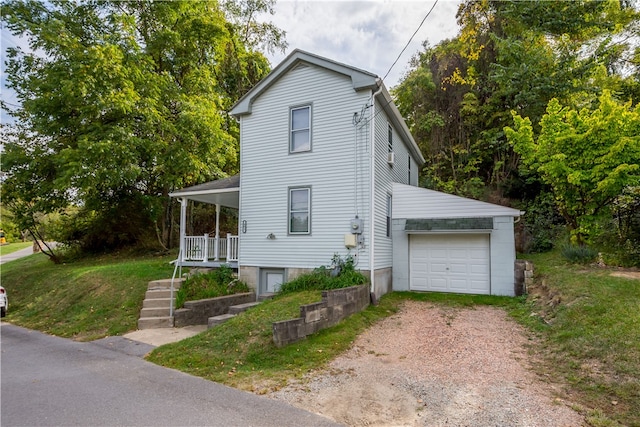 view of property exterior featuring a lawn, covered porch, and a garage