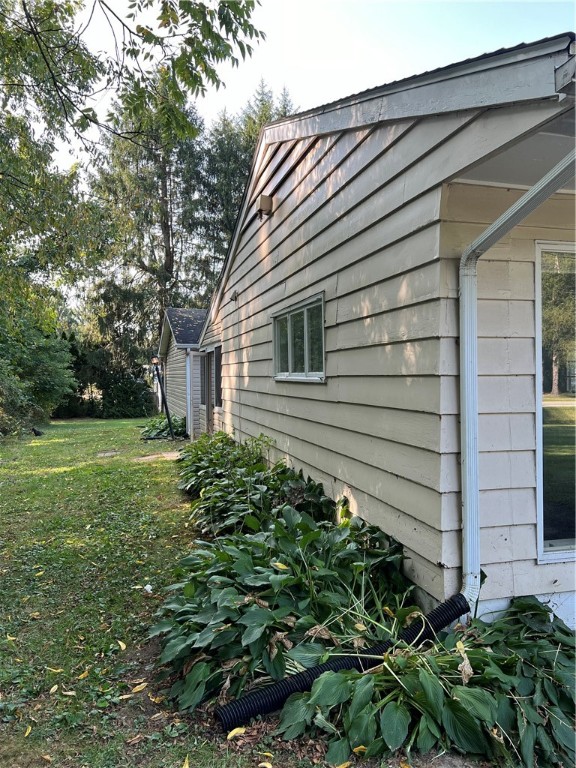 view of side of home with a lawn