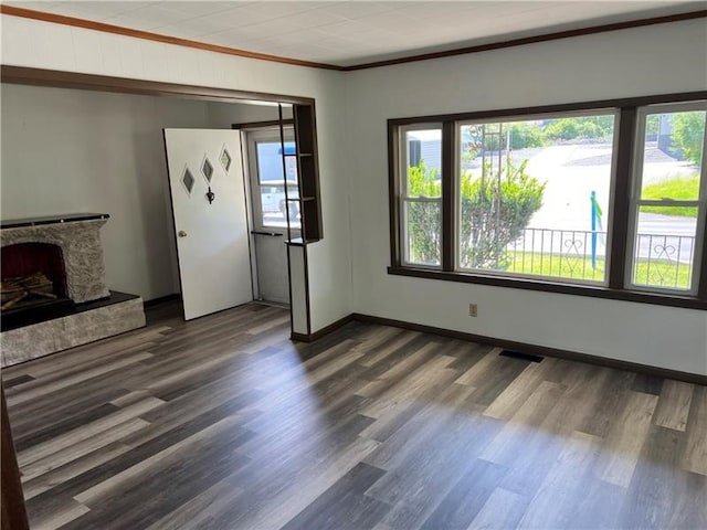 unfurnished living room with crown molding, a fireplace, and dark hardwood / wood-style flooring