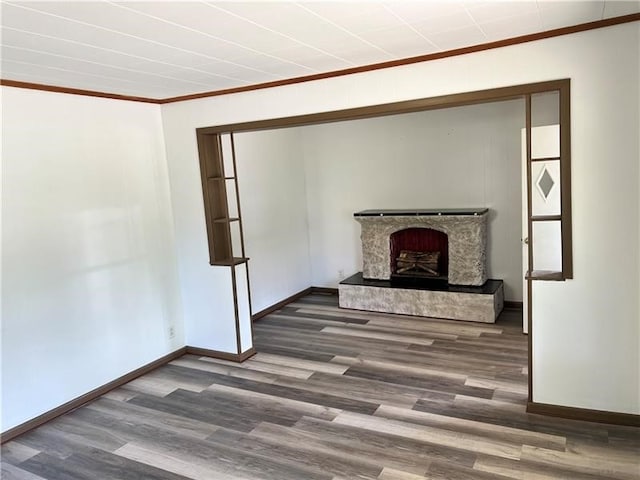 living room with a fireplace, ornamental molding, and hardwood / wood-style flooring