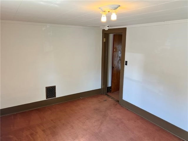 carpeted empty room featuring ornamental molding