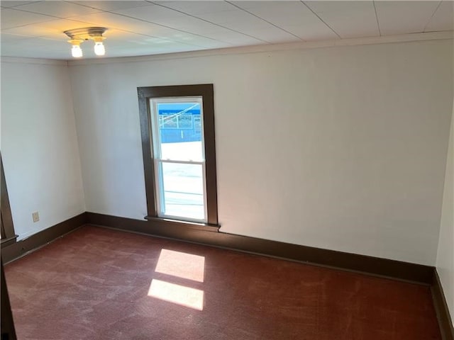 carpeted spare room with crown molding