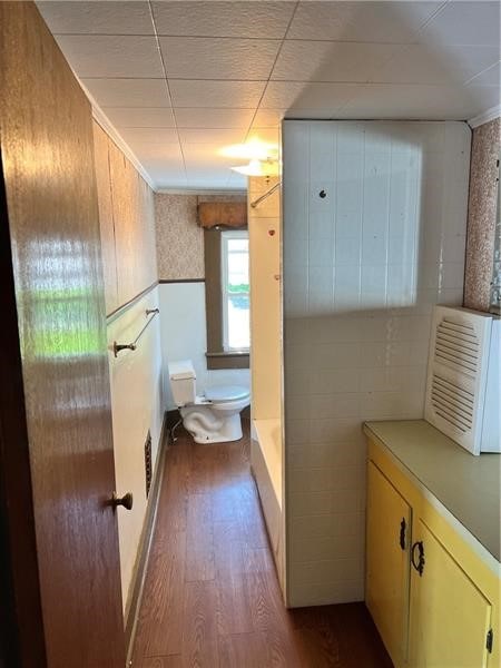 bathroom featuring wood-type flooring and toilet