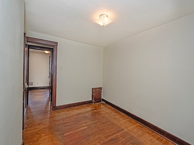 unfurnished room with hardwood / wood-style flooring