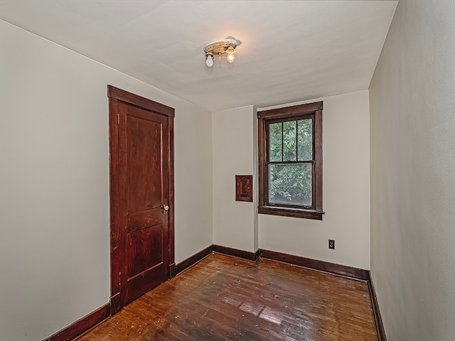 unfurnished room featuring dark wood-type flooring