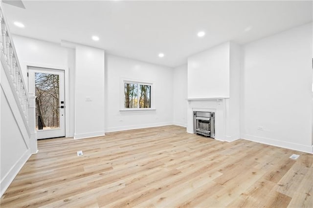 unfurnished living room with light hardwood / wood-style flooring