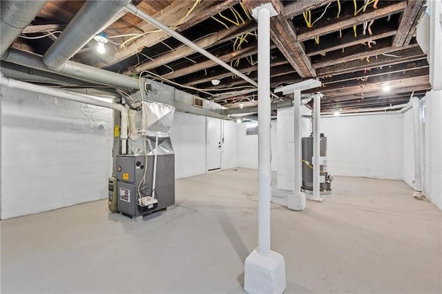 basement with gas water heater and heating unit