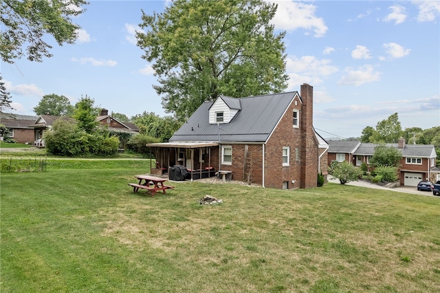 exterior space featuring a garage, a lawn, and central AC