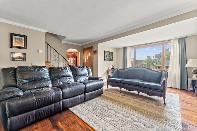 living room with crown molding and hardwood / wood-style floors