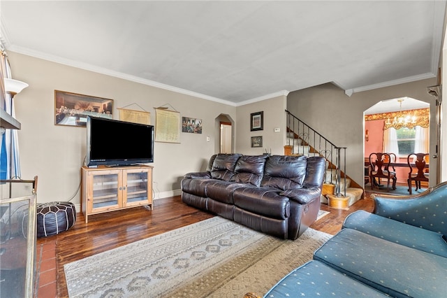 living room featuring ornamental molding, an inviting chandelier, and hardwood / wood-style floors