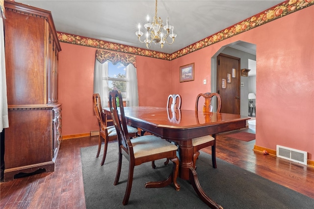 dining space with a notable chandelier and dark hardwood / wood-style floors