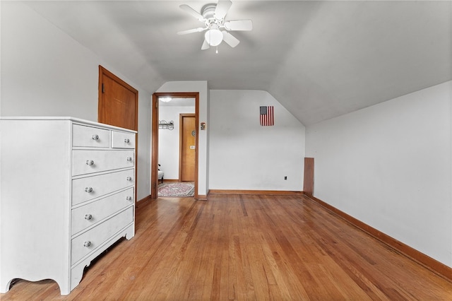 additional living space with vaulted ceiling, ceiling fan, and light hardwood / wood-style flooring