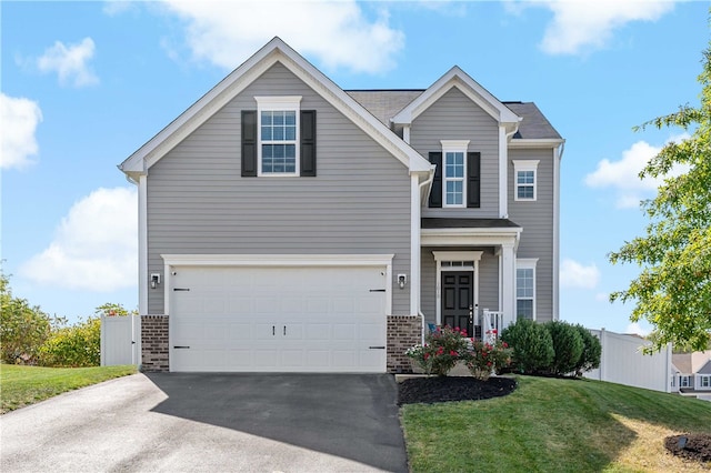 view of front of property featuring a garage and a front yard