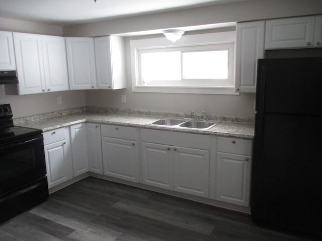 kitchen featuring exhaust hood, white cabinetry, sink, and black appliances