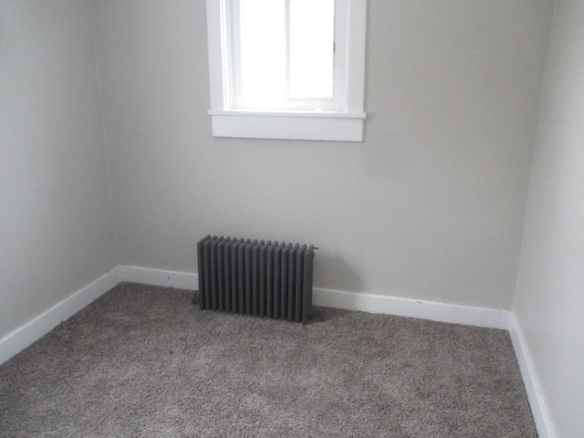 carpeted spare room with radiator