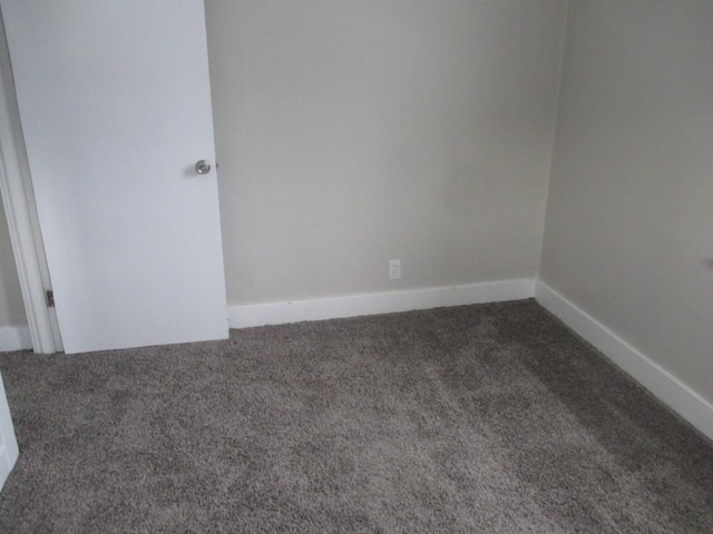 empty room featuring dark carpet