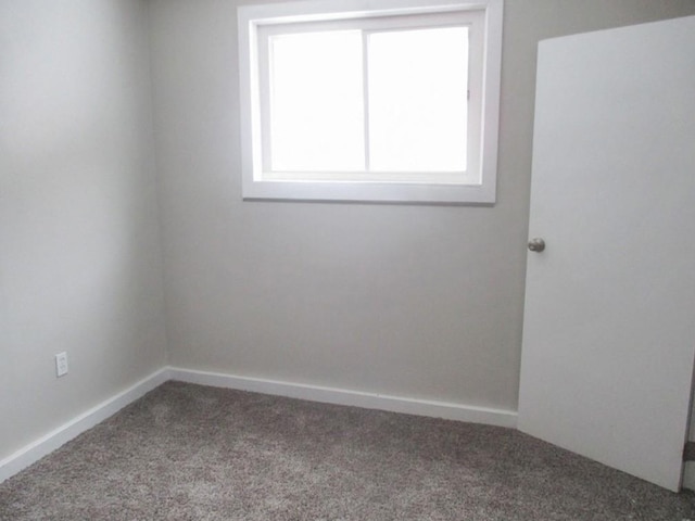 empty room with carpet floors and baseboards