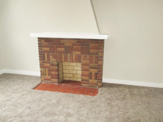 interior details with a fireplace, carpet flooring, and baseboards