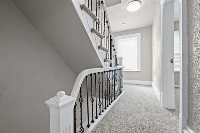 interior space featuring a textured ceiling and carpet flooring