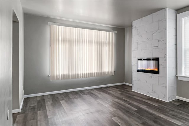 unfurnished living room featuring dark wood-type flooring and a fireplace