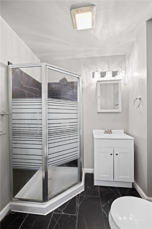 bathroom with vanity, toilet, and an enclosed shower